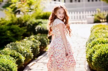 Beautiful charming redhead girl smiling on sunny day outdoors