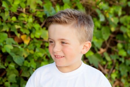 Happy little boy spending time in the park