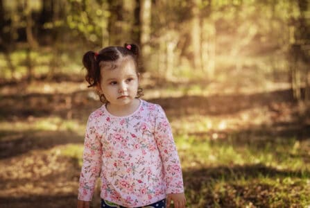 Cute little girl in autumn forest