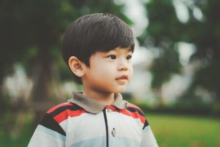 Little Asian boy spending time in the park