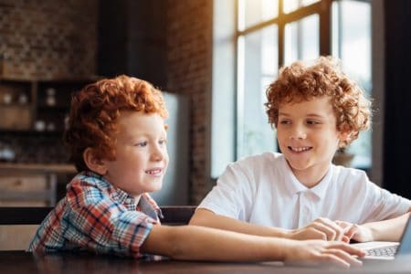 Smiling redhead Irish boy looking at his younger brother