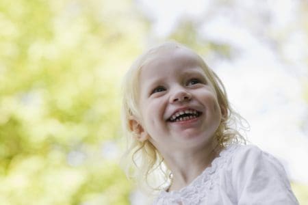 Happy Slavic girl playing in the park