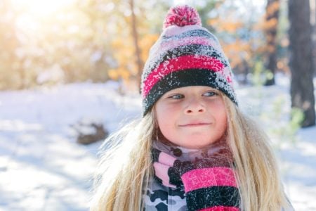 Happy Swedish girl playing in the snow