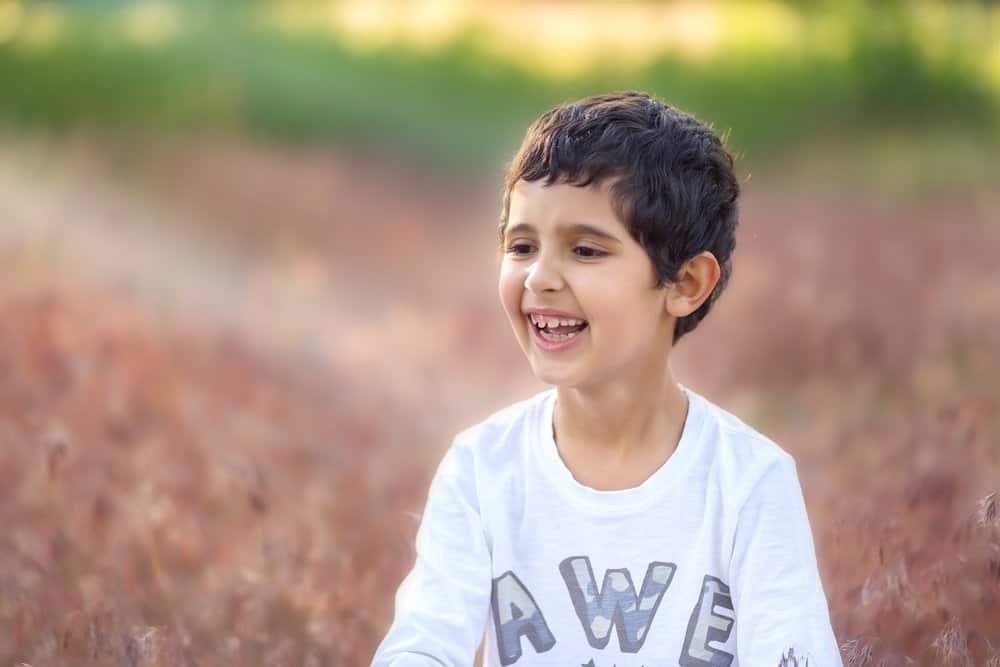 Happy little boy playing in the park.