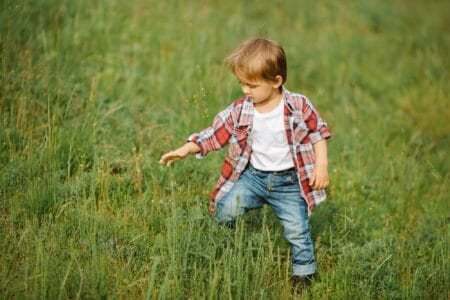 Happy little boy playing outdoor on the nature