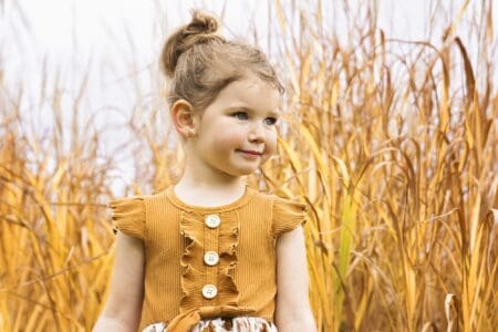 Adorable little young girl in autumn park