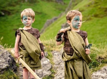 Two little boys dressed up as Celtic warriors playing outdoors