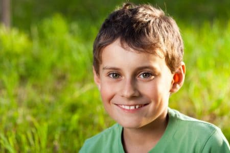 Smiling little boy spending time in the park