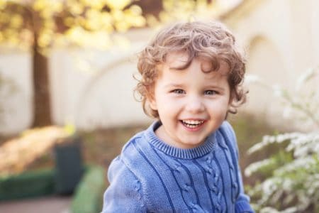 Happy little boy playing in the park