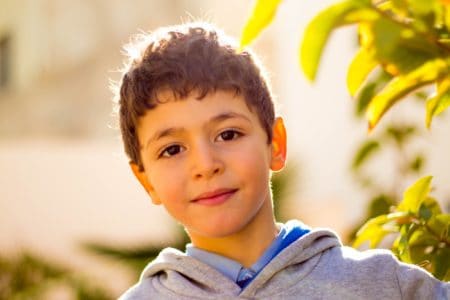 Cute little boy playing outside on a sunny day