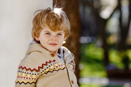 Cute blond little boy in the park