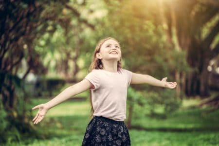 Happy little girl playing in the park