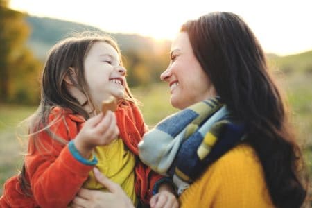 Happy European girl spending time with her mother in the park