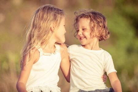 Two happy kids playing on the beach