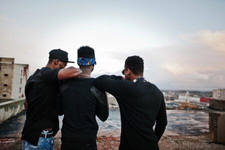 Three tough teenagers in standing on the rooftop