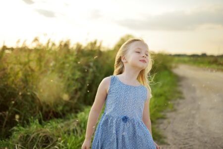 Little girl standing in the field