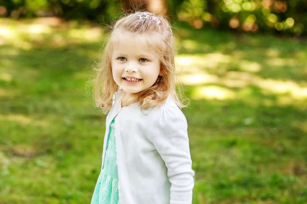 Blond little girl playing in the park.