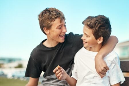 Two happy brothers hugging celebrating birthday