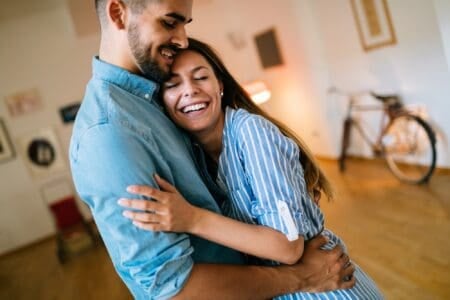 Couple hugging and smiling celebrating wife birthday with special wishes