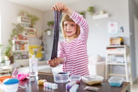 Young girl making stretchy slime