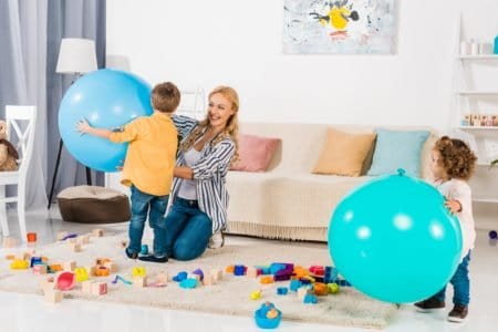 Mother and kids playing indoor games together