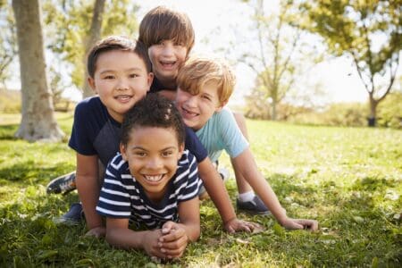 International group of boys lying on the grass