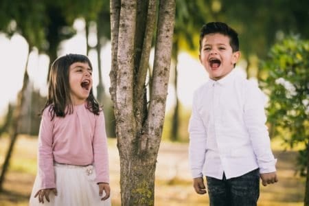 Cute little girl and boy playing at the park