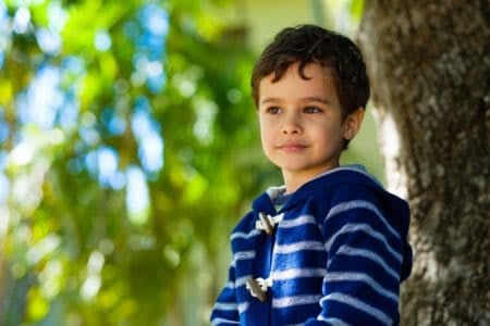 Adorable boy looking away on sunny day