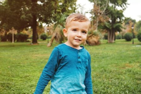 Happy little boy playing in the park