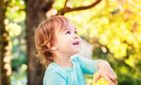 Happy toddler girl playing in the park