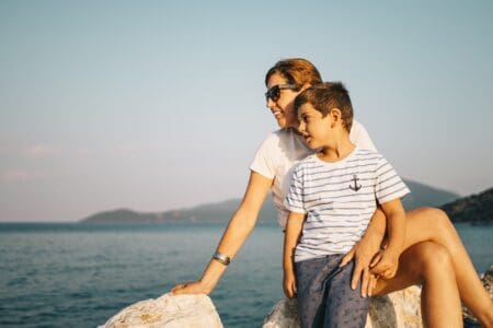 Mother and son spending time together looking at the sea