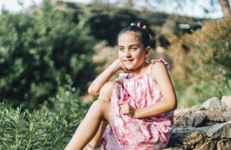 Cute girl spending time outdoors on a sunny day