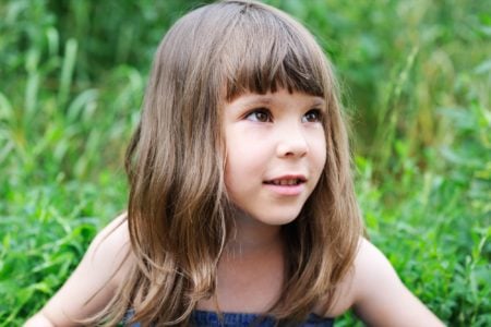 Adorable little girl spending time in the park