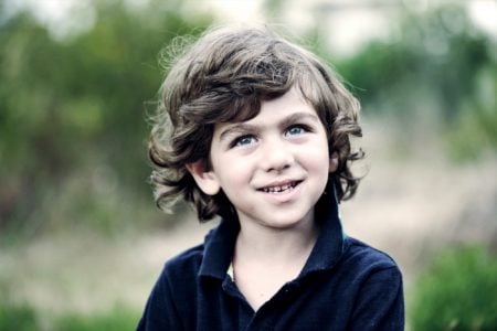 Smiling little kid playing in the park