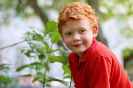 Happy little boy playing in the park