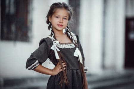 Beautiful little girl in a medieval dress standing outdoors