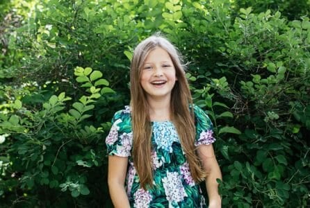 Pretty long haired girl smiling over nature background