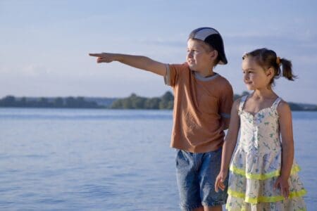 A boy and a girl spending time on the lakeshore