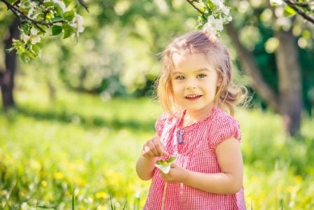 Happy little girl playing in the park