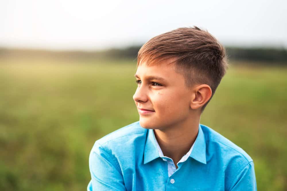 Little boy standing in the field