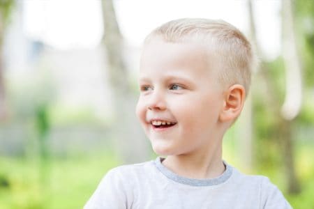 Happy Slavic boy playing in the park