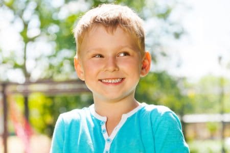 Happy little boy playing outdoors