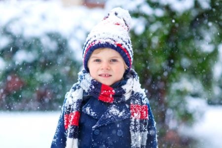 Happy Swedish boy playing in the snow