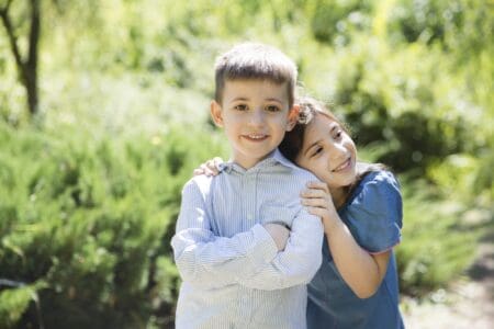 Sweet siblings spending time at the park on a sunny day