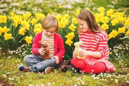 Kids playing with toy bunnies in the daffodil garden.