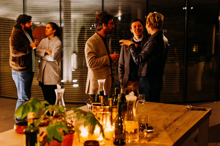 Five People Standing While Talking to Each Other