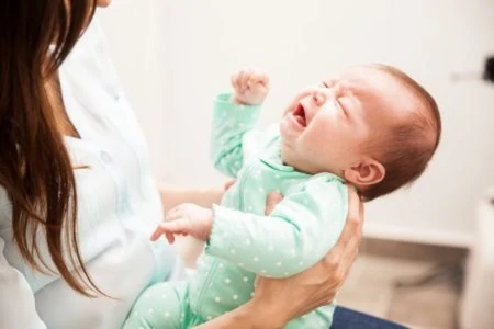 Mom carrying her crying baby