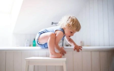 Toddler climbing into the bathtub unsupervised