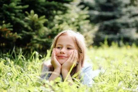 Happy girl lying in the grass.