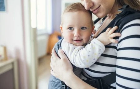 Mother wearing baby in a carrier